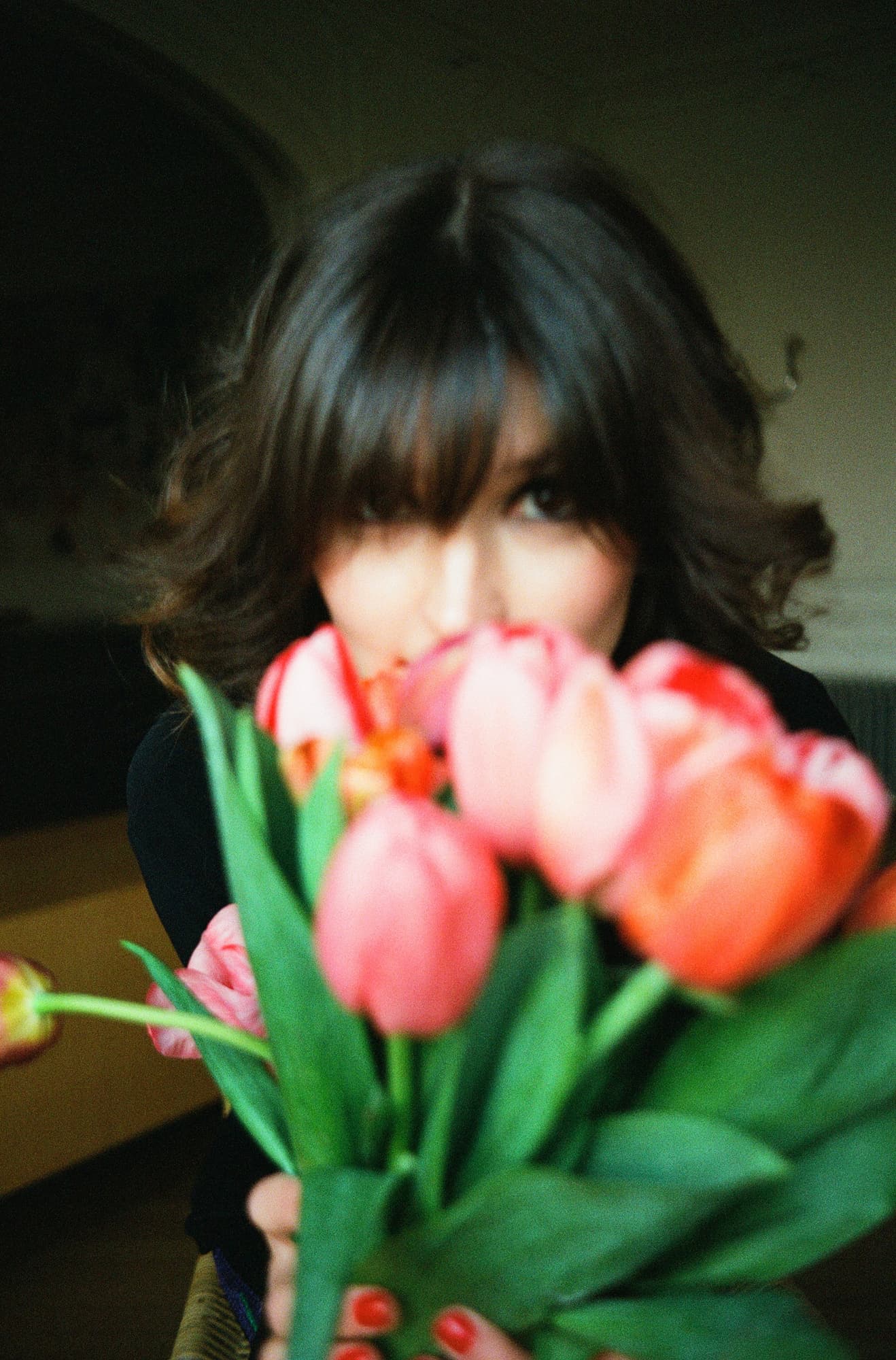 Ariadna partly hidden behind tulips at an apartment in Invalides, Paris