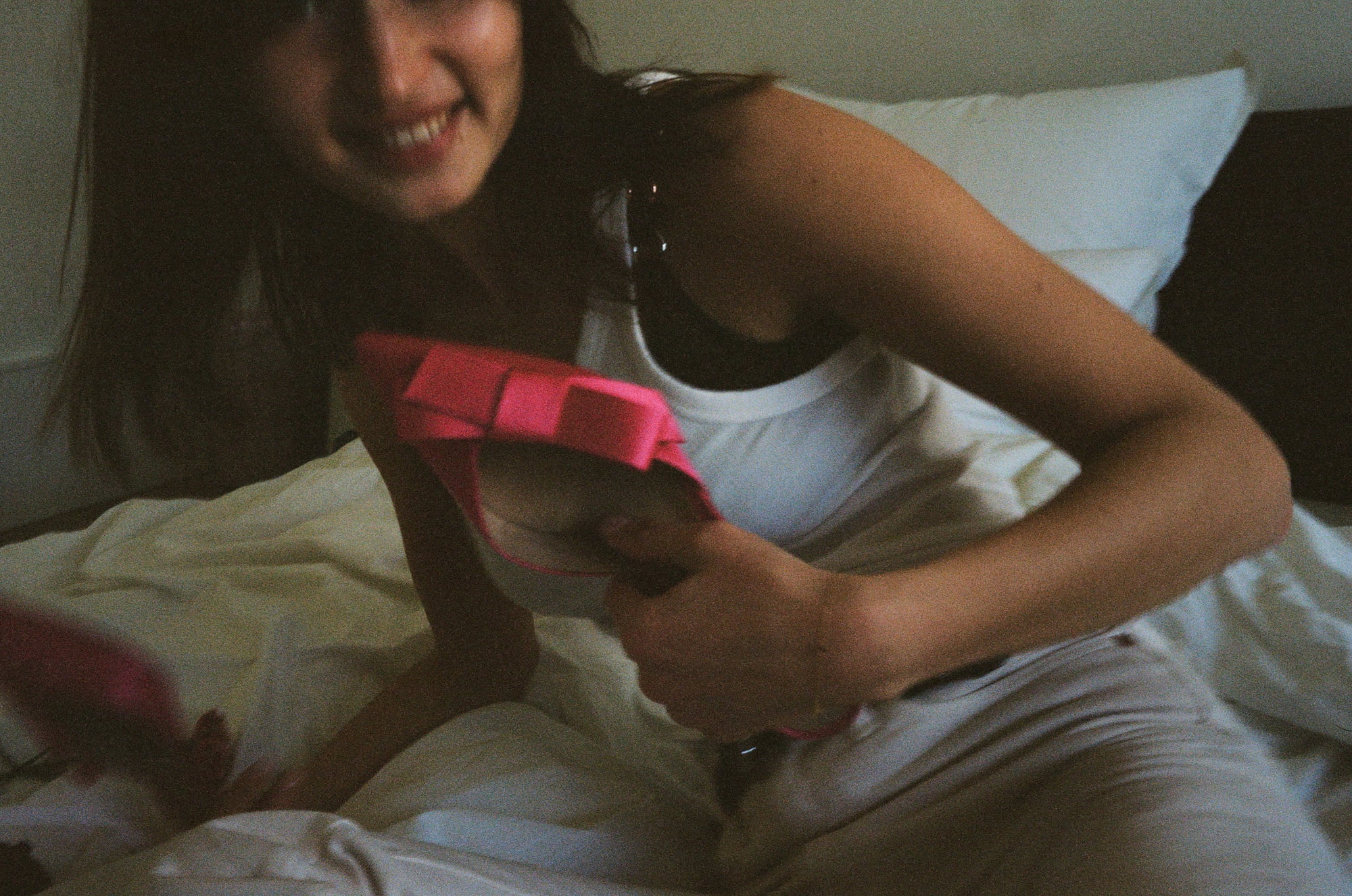 Ariadna smiling on a bed at her home in Paris