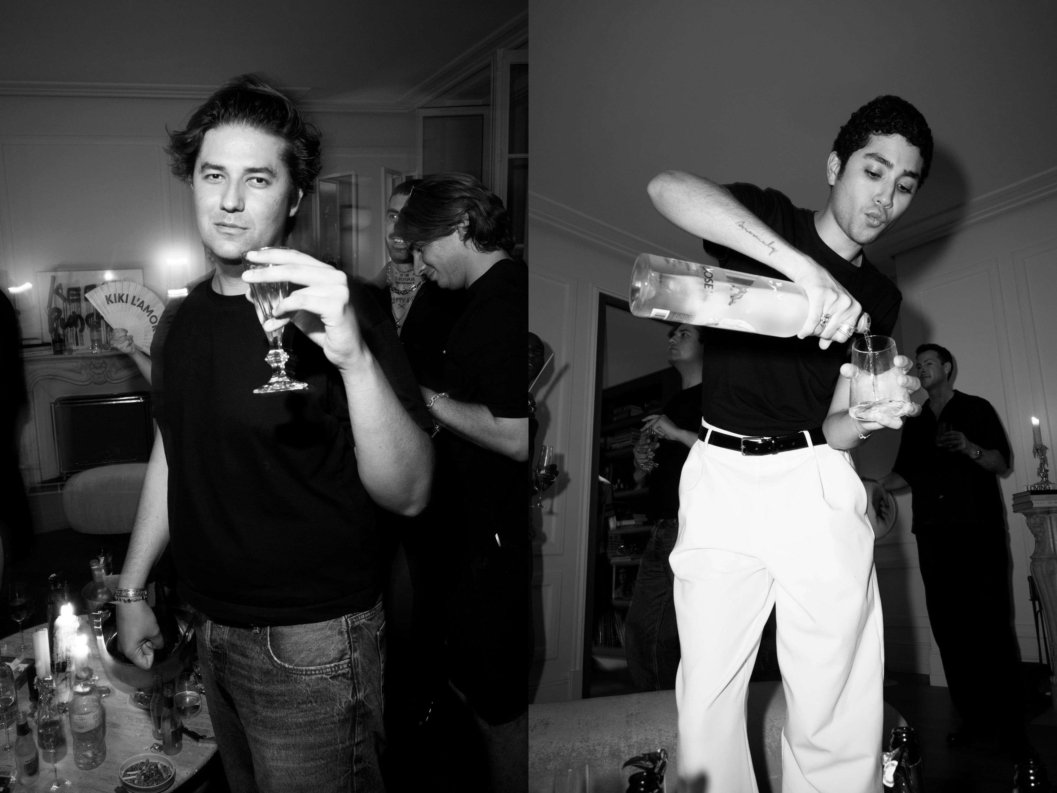 Guest holding a glass while another pours a drink in the living room.
