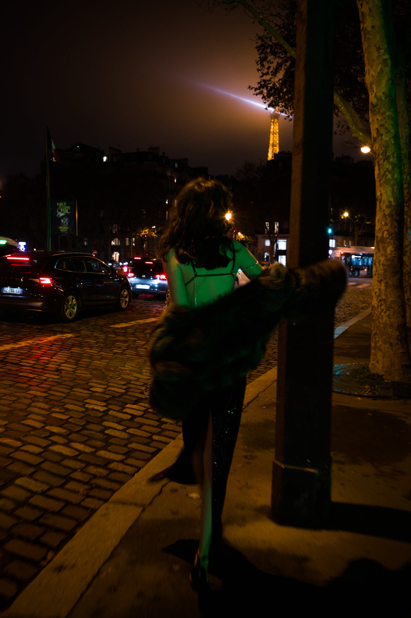 Polly Levin walking at night in Paris with the Eiffel Tower in the background for BlancBloom AW25