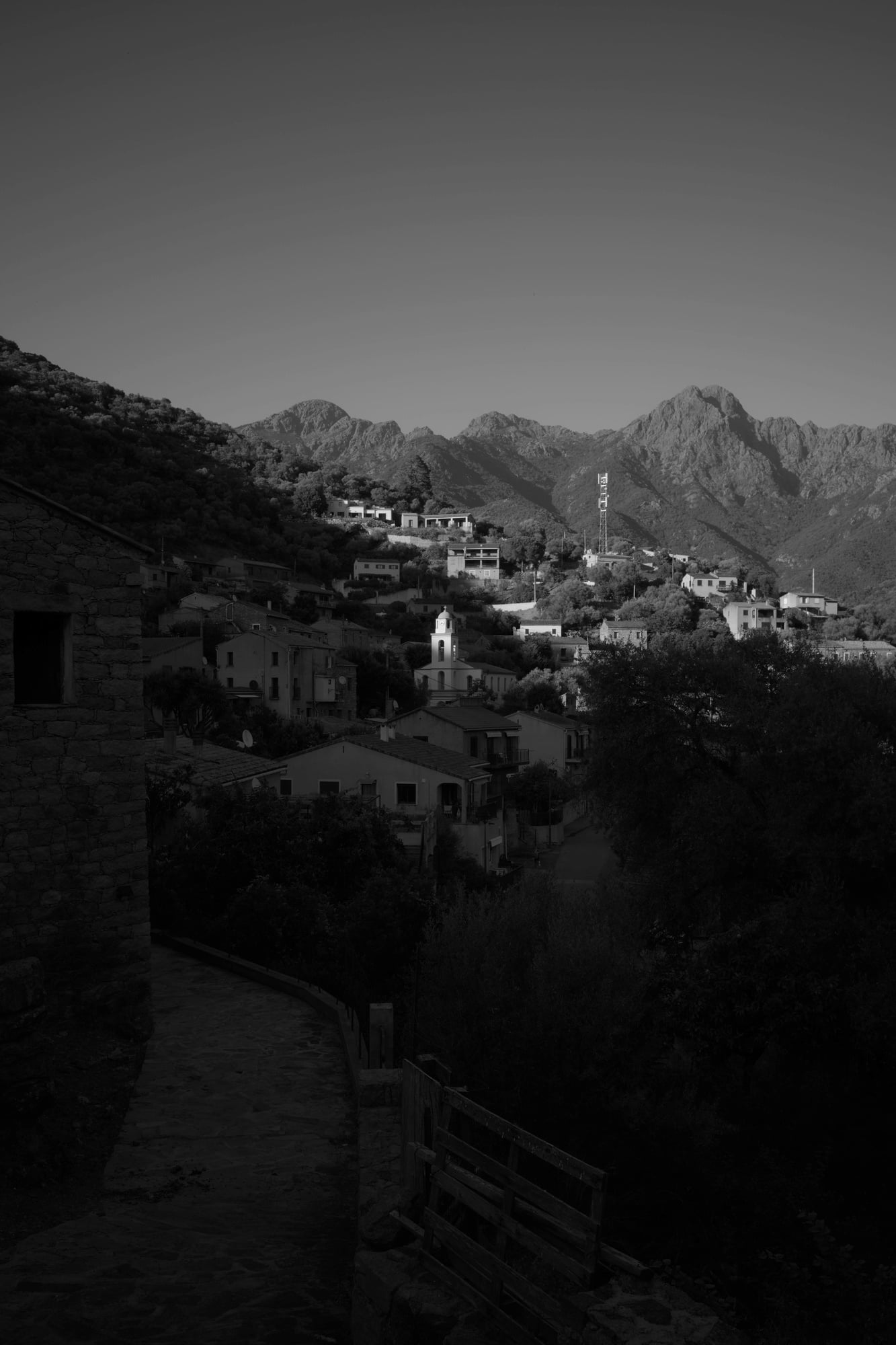 Black-and-white view over Serriera and the surrounding Corsican mountains.