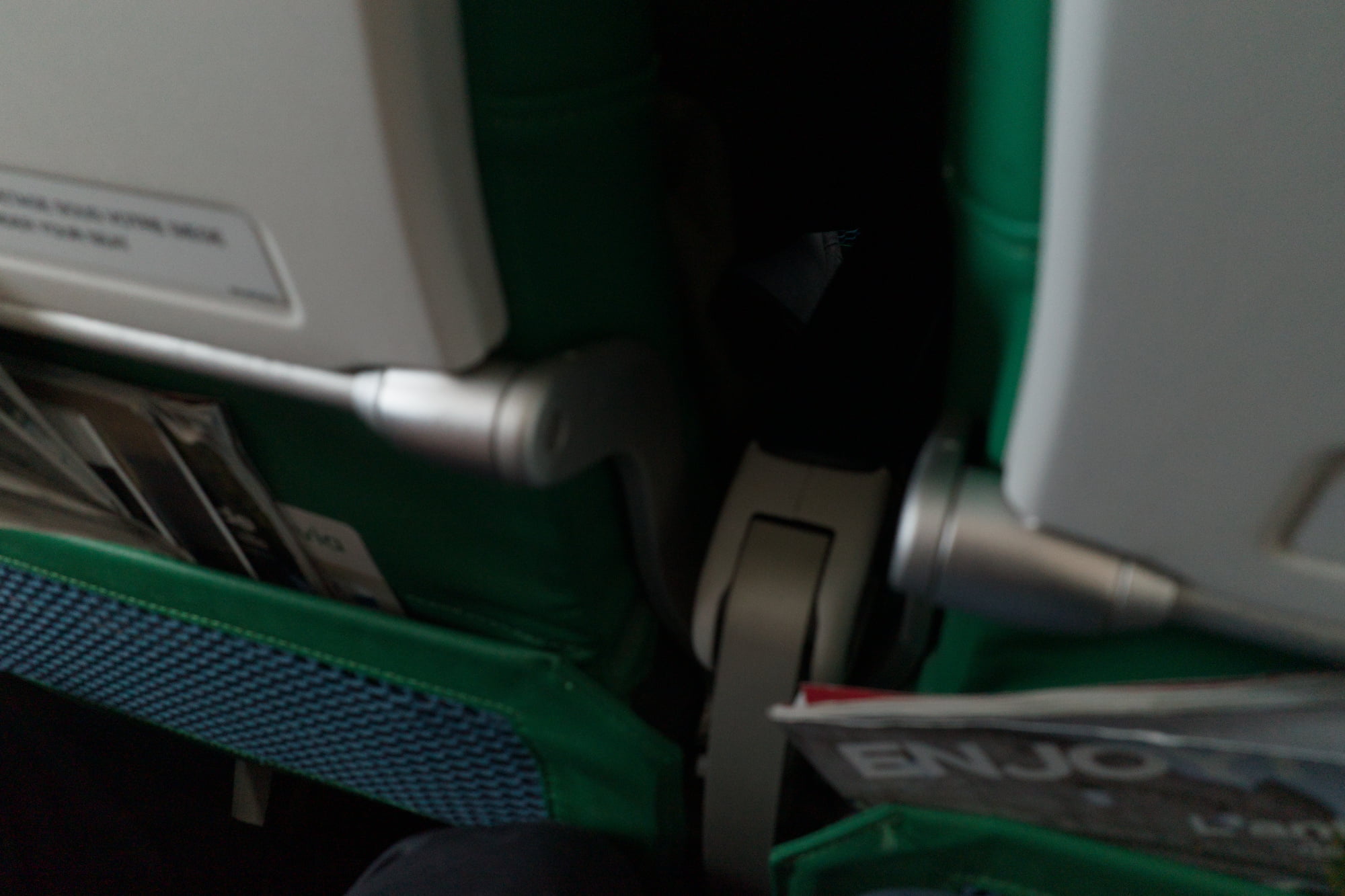 Close view of green train seats and folded travel items on the way to Palermo