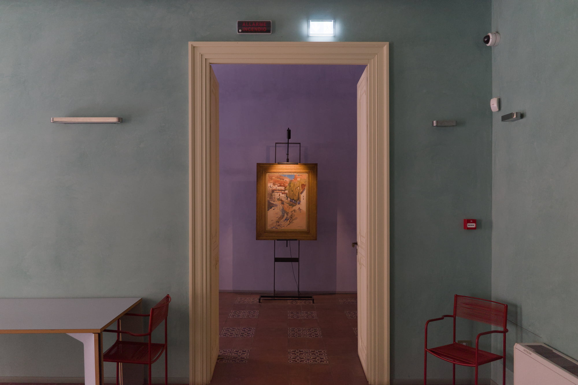 Palazzo Butera museum interior with green walls and a purple doorway framing a small painting