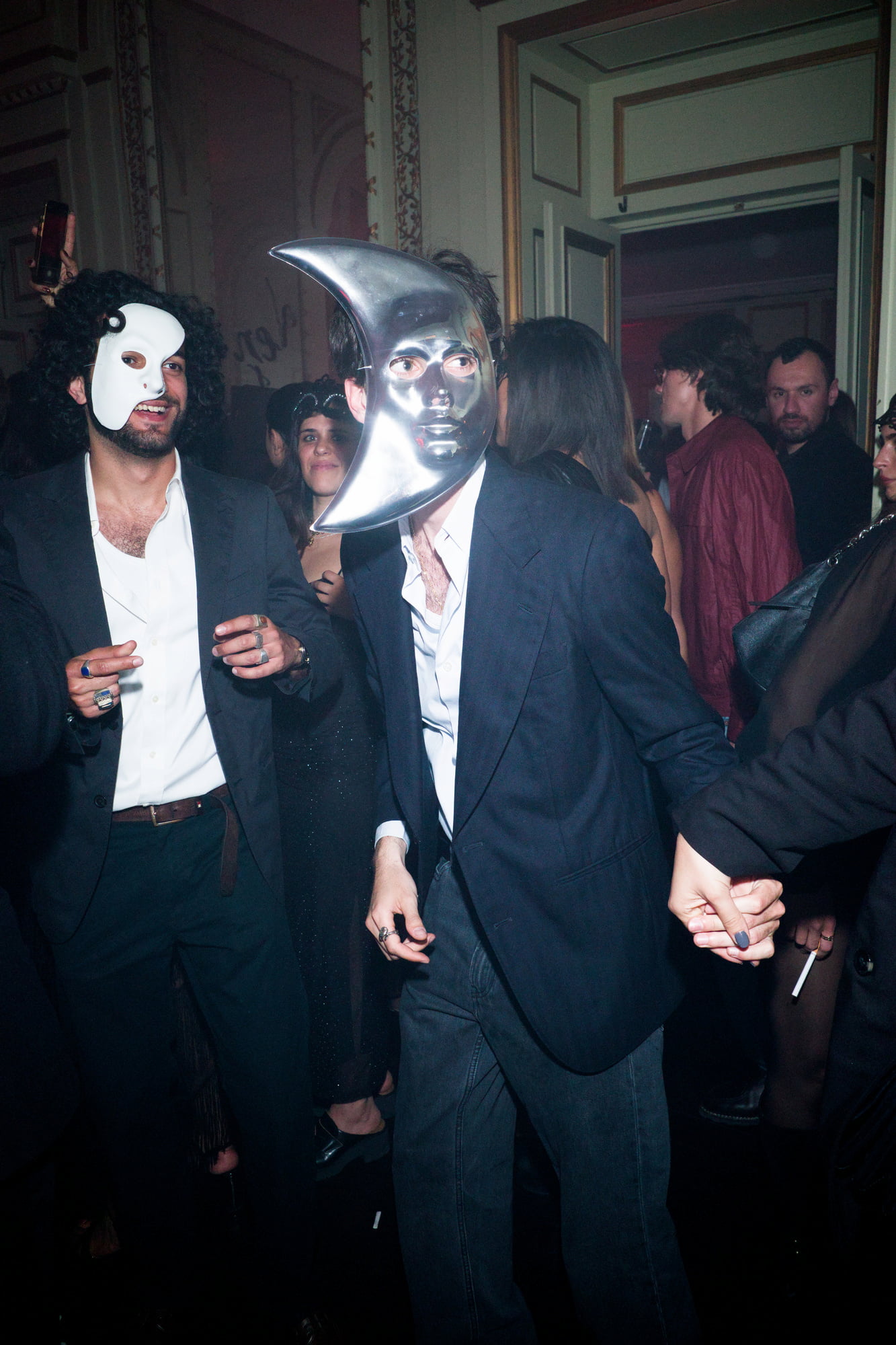 Masked guests dancing at masquerade ball