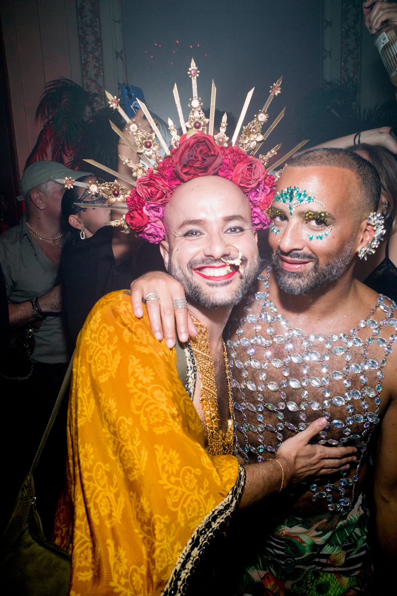 Costumed guests posing with ornate crowns