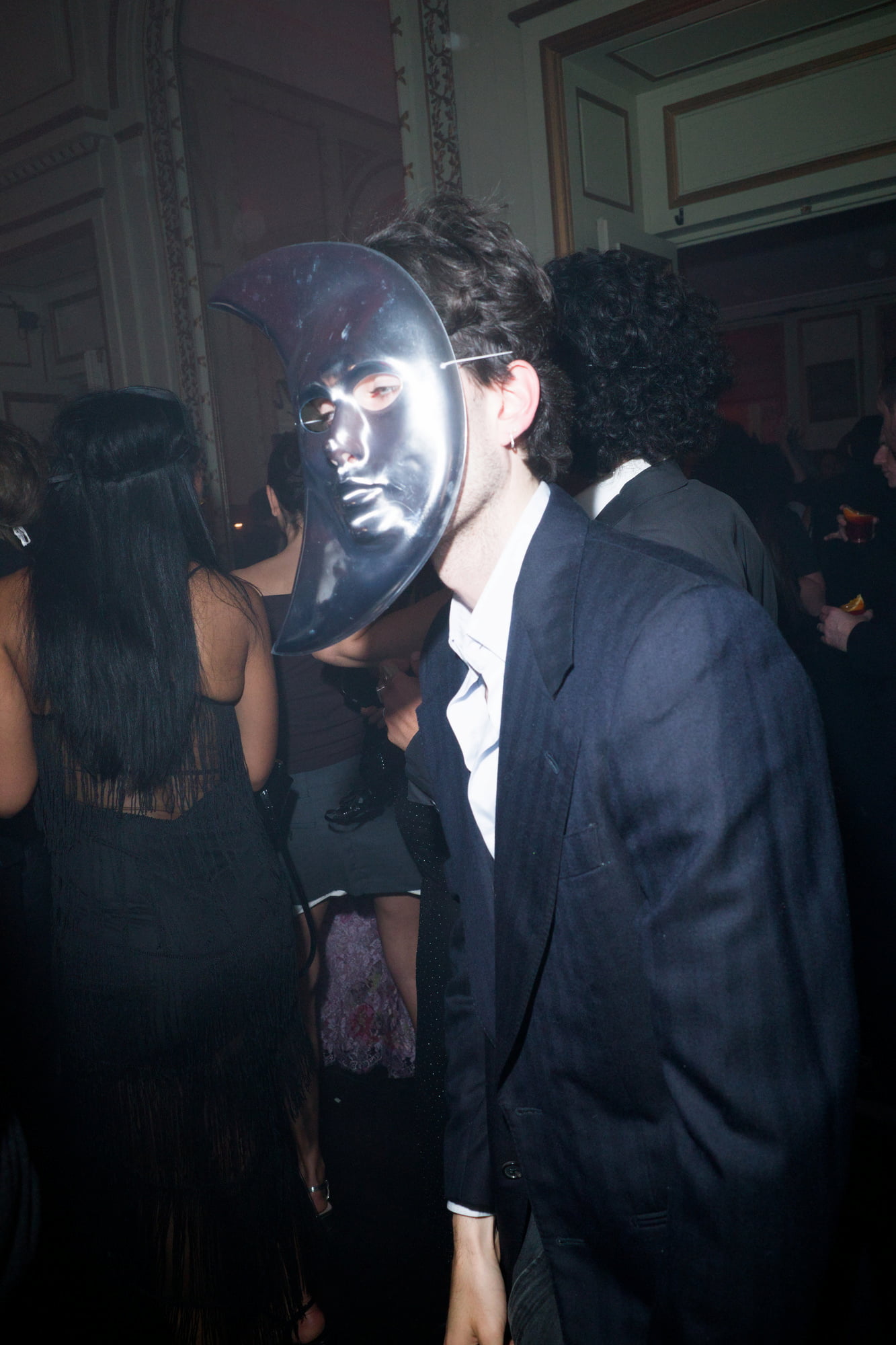 Man wearing moon mask dancing