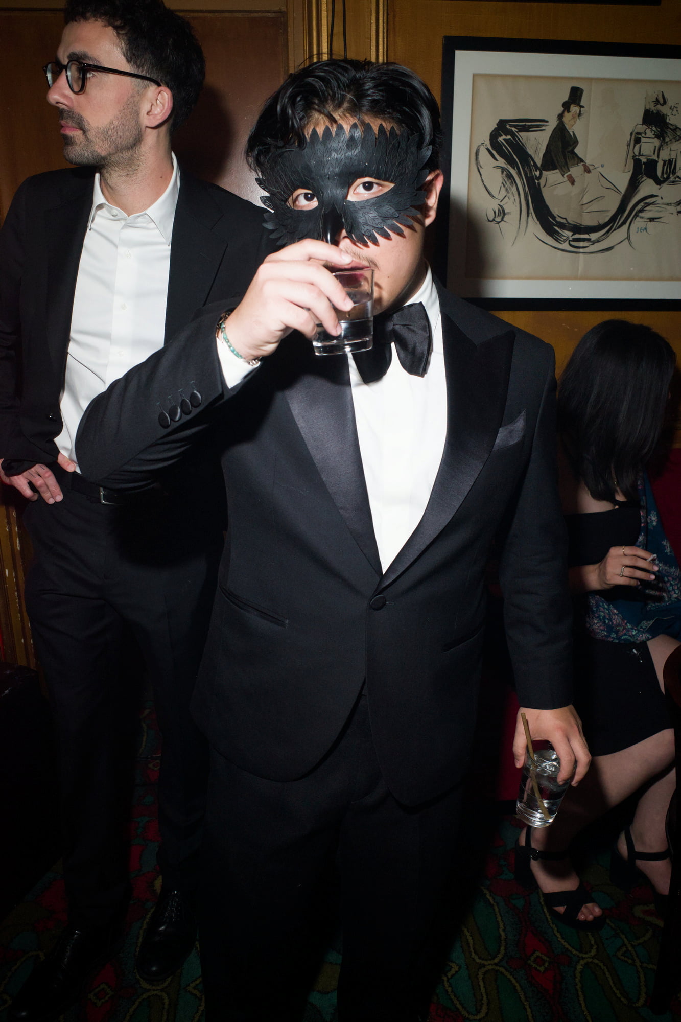 Man in tuxedo wearing black mask