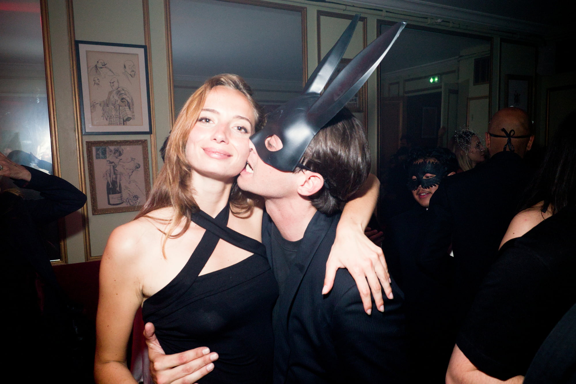 Couple embracing at masquerade event