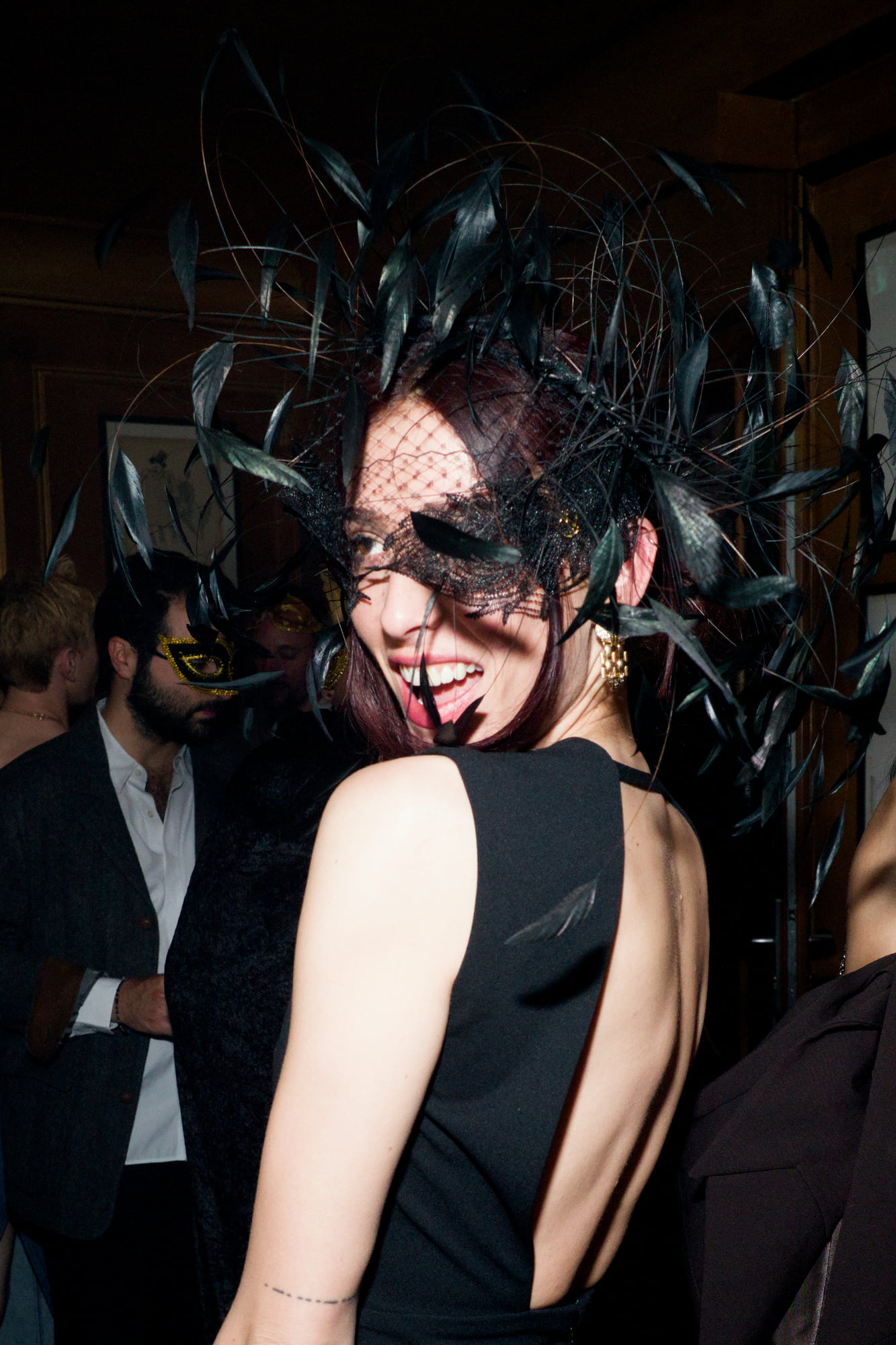 Woman with feather mask dancing
